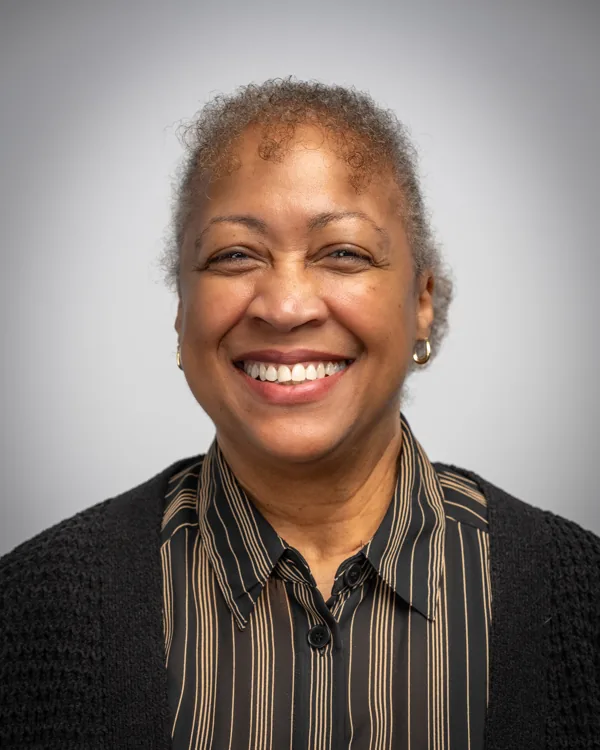 Smiling studio headshot with a patterned scarf