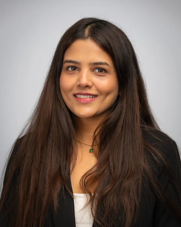 Studio headshot in a black blazer