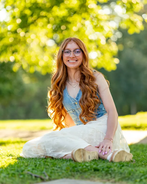 Outdoor senior portrait seated in warm afternoon light