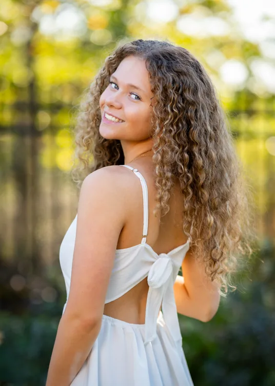 Outdoor senior portrait in a white dress