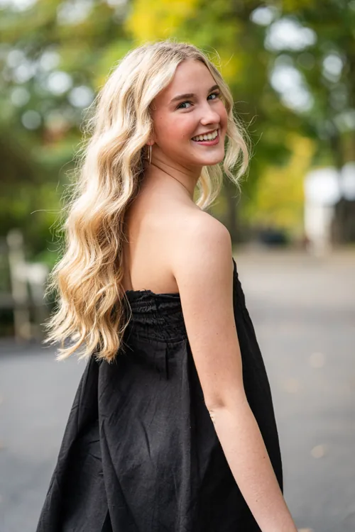 Senior portrait on a tree-lined path