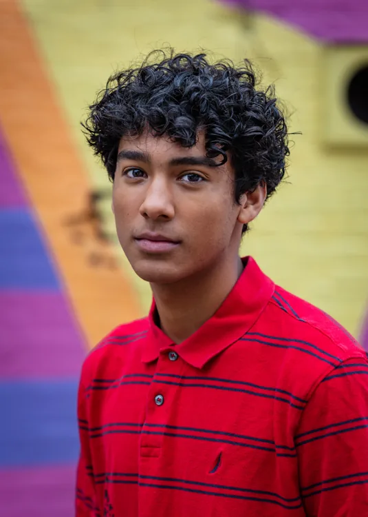Senior portrait against a colorful mural